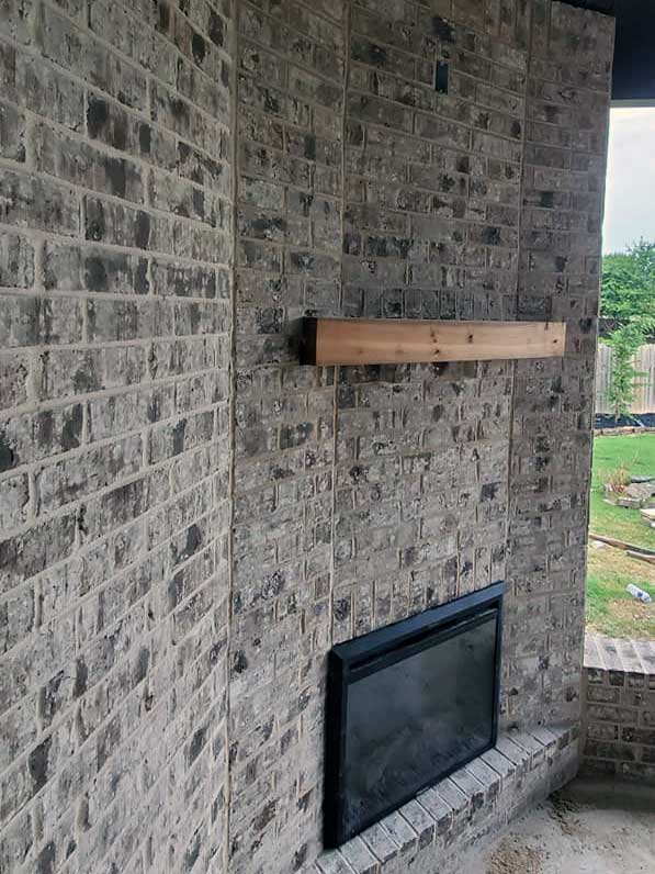 Custom brick fireplace made by outdoor kitchen designer American Masonry Arts in Northwest Arkansas