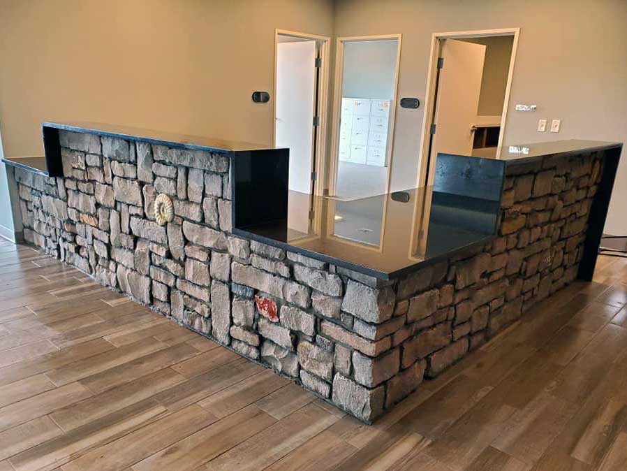 Artisan stone indoor dividing wall created by commercial masonry contractors - American Masonry Arts in Northwest Arkansas