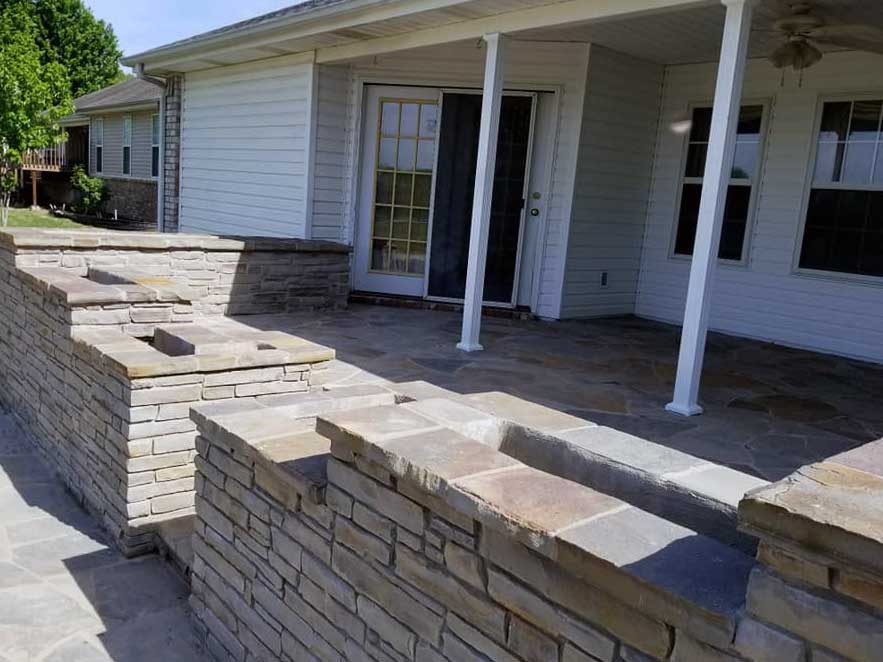 Stone walls with built-in planters built by stone patio contractor American Masonry Arts